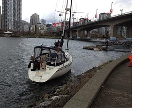 A boat drifts in False Creek Tuesday as a wind warning remains in effect in southern B.C.