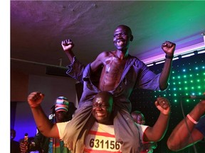 Mison Sere, right, smiles after winning the 2015 edition of the Mr Ugly competition, in Harare, Saturday, Nov. 21.2015. Left: Last year's winner, William Masvinu, poses for a photo in Harare.