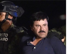 Drug kingpin Joaquin "El Chapo" Guzman is escorted into a helicopter at Mexico City's airport on Jan. 8, 2016, following his recapture during an intense military operation in Los Mochis, in Sinaloa State.
