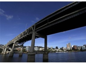 FILE - In this Aug. 4, 2015, file photo, downtown Portland, Ore., is visible under the Interstate-5 Marquam Bridge on the Willamette River. There are numerous bridges in Portland spanning the river, varying in age and ability to withstand a major earthquake. For the past few years emergency officials in the Pacific Northwest have been drafting detailed contingency plans for the day a mega-quake and tsunami hit the region. What planners envision is a massive response that would eclipse the response to any natural disaster so far in U.S. history.