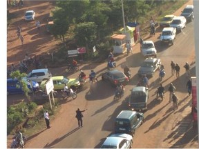 Mali troopers help a hostage leave the Radisson Blu hotel after gunmen attacked the hotel .