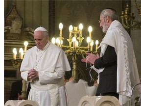 Pope Francis flanked by Rabbi Riccardo Di Segni, right, during his visit to the Great Synagogue of Rome, Sunday, Jan. 17, 2016. Pope Francis made his first visit to a synagogue as pope Sunday, greeting Rome's Jewish community in their house of worship as his two predecessors did in a show interfaith friendship at a time of religiously-inspired violence around the globe.