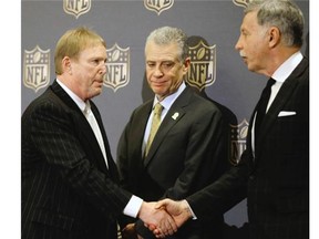 Oakland Raiders owner Mark Davis (left) shakes hands with St. Louis Rams owner Stan Kroenke (right) as Pittsburgh Steelers president Art Rooney II looks on after an NFL owners meeting on Tuesday, Jan. 12, 2016, in Houston. The owners voted to allow the Rams to move to a new stadium just outside Los Angeles, and the San Diego Chargers will have an option to share the facility.