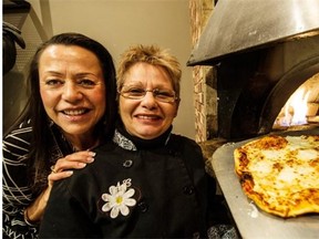 Owner Freida Paterson (left) and chef Angela Chiovitti with a pizza out of the oven at Pasta Vino Trattoria & Bar.