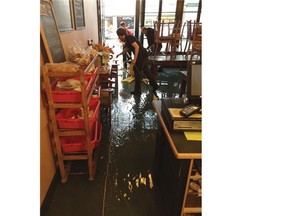 Owners of Savary Island Pie Company clean up a sewage leak at the Ambleside store.