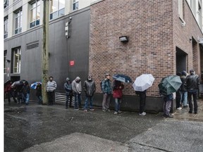 People line up for the lunch services at Union Gospel Mission in Vancouver’s Downtown Eastside on Monday, Nov. 16.