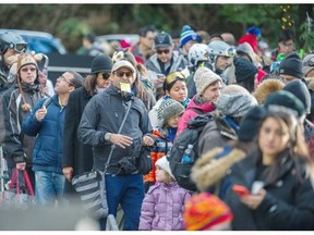 People wait in line for up to an hour and a half to ride the tram at Grouse Mtn in North Vancouver, BC. December 29, 2015.