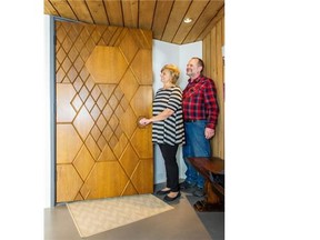 Jan Pidhirny and Jim Ferguson with the now famous front door of their Ron Thom designed home in West Vancouver.