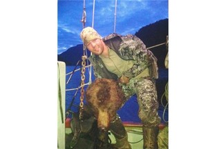 NHL player Clayton Stoner holds up a grizzly bear head in this photo taken in May 2013. Stoner is guilty of one charge in relation to illegally hunting a grizzly bear on British Columbia's central coast.