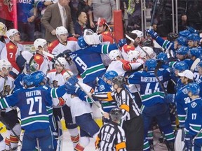 Players from the Vancouver Canucks and the Florida Panthers mix it up a bit in a ‘small brawl’ — not the real McCoy — following the Canucks’ 3-2 overtime win in their NHL game at Vancouver’s Rogers Arena on Monday, Jan. 11, 2016.