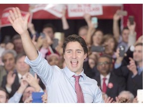 File: Prime Minister-designate Justin Trudeau waves to supporters as he steps onto the stage during a welcome rally in Ottawa, on October 20, 2015.