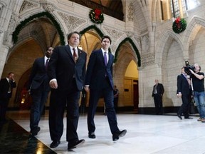Prime Minister Justin Trudeau arrives at a caucus meeting on Parliament Hill with Liberal MP Mauril Belanger.