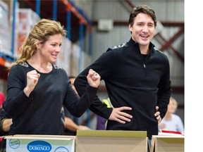 Prime Minister Justin Trudeau and his wife Sophie prepare a Christmas basket at Montreal food bank.
