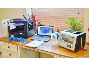 The ProtoCycler, right, with a spool of freshly generated filament attached, and a 3D printer on the left. In this case, the printer has printed prototypes for fan ducts (blue, foreground), but it generally shows what your future desk could one day look like — picture recyclable water bottles on the right, and a new pair of shoes on the left.