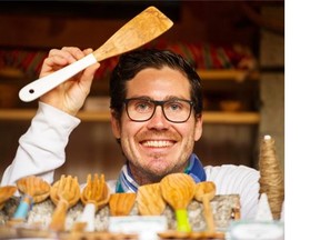 Provence en Couleur’s Eric Mourre holds olive wood kitchen utensils from France at his kiosk at the Vancouver Christmas Market.