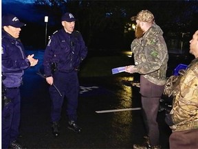 Provincial conservation officers Sgt. Simon Gravel , left, and Insp. Chris Doyle speak with legal hunters Jesse Burroughs, with beard, of Langley and Matt Powel of Ladner during a poaching patrol in South Delta.