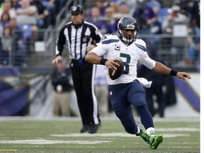 Quarterback Russell Wilson #3 of the Seattle Seahawks carries the ball against the Baltimore Ravens in the third quarter at M&T Bank Stadium on December 13, 2015 in Baltimore, Maryland.