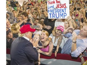 Republican presidential candidate Donald Trump greets enthusiastic supporters in Mobile, Alabama.