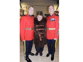 Retired hockey broadcast legend Howie Meeker in an antique buffalo coat and fur hat, flanked by Burnaby RCMP Staff Sgt. Major John A. Buis, right, and Buis’s son Jamie at the latter’s graduation from the force in 2013 in Regina.