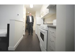 Rich Coleman, minister of natural gas development and housing, tours the Budzey Building, a newly completed structure providing 147 apartments for women or women with kids who are homeless or at risk of homelessness, in Vancouver on Thursday.