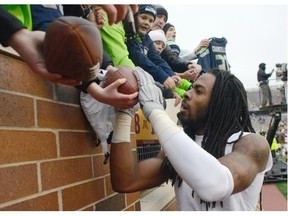 Richard Sherman of the Seattle Seahawks signs autographs for fans in Minneapolis, Minn., after his team beat the Minnesota Vikings on Dec. 6. Although his interceptions are at a career low at two, he has been willing to take more challenging matchups.