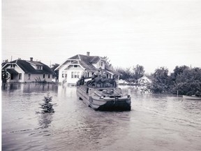 A rowboat and a pontoon-like vessel navigate through a flooded residential neighbourhood inMatsqui during the 1948 Fraser River flood.