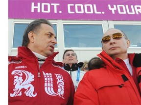 Russian President Vladimir Putin (right) with his sports minister, Vitaly Mutko, during a nordic skiing event at the 2014 Sochi Winter Olympics on Feb. 16, 2014.
