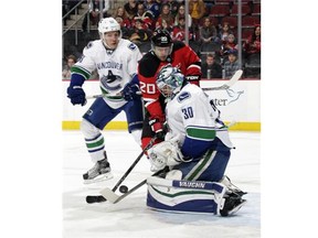 Ryan Miller #30 of the Vancouver Canucks makes a save against Lee Stempniak #20 of the New Jersey Devils during the second period at the Prudential Center on November 8, 2015 in Newark, New Jersey.