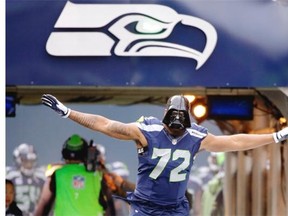 Seattle Seahawks’ Michael Bennett wears a “Darth Vader” mask as he runs onto the field during pregame introductions before an NFL football game against the Cleveland Browns, Sunday, Dec. 20, 2015, in Seattle.