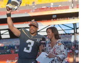 Seattle Seahawks quarterback Russell Wilson (3) of Team Irvin reacts after winning offensive MVP award while being interviewed by ESPN sideline reporter Lisa Salters at the NFL Pro Bowl football game Sunday, Jan. 31, 2016, in Honolulu. Team Irving beat Team Rice 49-27.