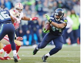Seattle Seahawks running back Thomas Rawls, right, rushes against the San Francisco 49ers during the first half of an NFL football game, Sunday, Nov. 22, 2015, in Seattle.