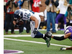 Seattle Seahawks wide receiver Doug Baldwin (89) scores a touchdown on a 20-yard reception as Minnesota Vikings cornerback Antone Exum (32) defends in the first half of an NFL football game Sunday, Dec. 6, 2015 in Minneapolis.
