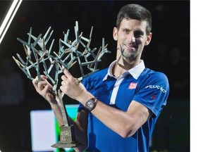 Serbia’s Novak Djokovic holds the trophy after winning the final of the BNP Masters tennis tournament in two sets, 6-2, 6-4, against Britain’s Andy Murray at the Paris Bercy Arena, in Paris, France, Sunday, Nov. 8, 2015.