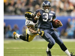 Shaun Alexander tries to avoid a tackle by Pittsburgh Steelers linebacker Joey Porter in the third quarter of Super Bowl XL in Detroit in February 2006. The Seahawks lost the game 21-10.