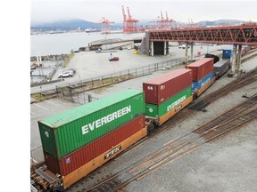 Shipping containers sit on rail cars on a siding near the Port of Vancouver.