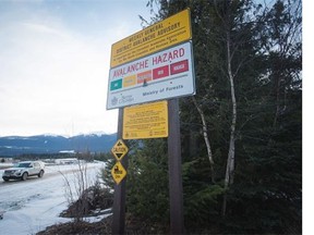 A sign showing an avalanche hazard warning of “considerable” is seen at a parking lot where snowmobilers embark for Mount Renshaw. The sign uses data from a different area, the Cariboo region.