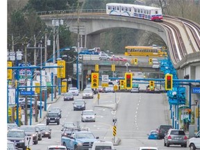 A 49-year-old Surrey man has pleaded guilty to charges relating to break-ins at two New Westminster SkyTrain stations and bank machines. A SkyTrain travels over North Road in Burnaby.