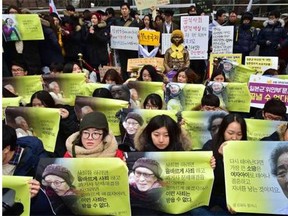 South Korean supporters hold portraits of former ‘comfort women’, who were forced into wartime sexual slavery for Japanese soldiers, during an anti-Japanese rally in front of the Japanese embassy in Seoul last week.