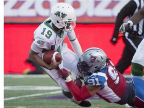 Saskatchewan Roughriders' Keith Price (19) is sacked by Montreal Alouettes' Alan-Michael Cash during second half CFL football action, in Montreal, on Sunday, Nov. 8, 2015. THE CANADIAN PRESS/Graham Hughes