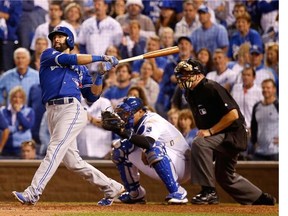 Members of the Toronto Blue Jays look on as fans celebrate after the Kansas City Royals defeated them in Game 6 of the American League Championship Series.