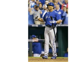 Toronto Blue Jays' Jose Bautista gestures after a fan caught a home run by Kansas City Royals' Mike Moustakas during the second inning of Game 6.