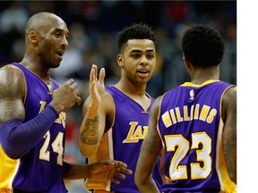 Los Angeles Lakers forward Kobe Bryant waves to the crowd after an NBA basketball game against the Washington Wizards.