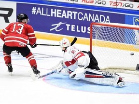 Canada's Mathew Barzal puts the game-winning shot past Switzerland's Joren van Pottelberghe during a shootout in preliminary round hockey action at the IIHF World Junior Championship in Helsinki, Finland on Tuesday, December 29, 2015. THE CANADIAN PRESS/Sean Kilpatrick