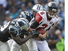 Carolina Panthers' Ted Ginn breaks a tackle of Atlanta Falcons' Ricardo Allen to run for a touchdown after a catch in the first half.