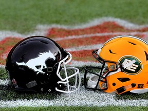 Helmets of the Calgary Stampeders and Edmonton Eskimos line up on the field at Commonwealth Stadium in Edmonton, Alta., on  Nov 21, 2015.