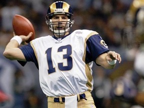 FILE - In this Feb. 3, 2002, file photo, St. Louis Rams quarterback Kurt Warner looks to pass to Marshall Faulk in the first quarter against the New England Patriots in Super Bowl XXXVI at the Louisiana Superdome in New Orleans.