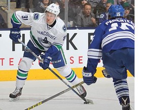 Jared McCann #91 of the Vancouver Canucks fires a shot against the Toronto Maple Leafs during an NHL game at the Air Canada Centre on November 14, 2015 in Toronto, Ontario, Canada.