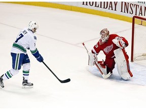 Vancouver Canucks right wing Linden Vey (7) scores the winning shootout goal on Detroit Red Wings goalie Jimmy Howard (35) during an NHL hockey game Friday, Dec. 18, 2015 in Detroit. Vancouver won 4-3 in a shootout.