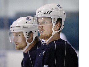 Daniel Sedin congratulates teammate Markus Naslund #19 after scoring against the Calgary Flames during a game at General Motors Place November 18, 2007 in Vancouver, British Columbia, Canada.