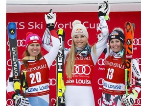 Lindsey Vonn kisses the trophy as she celebrates her win on the podium following the women's World Cup Super-G ski race, in Lake Louise, Alta., on Sunday, Dec. 6, 2015.